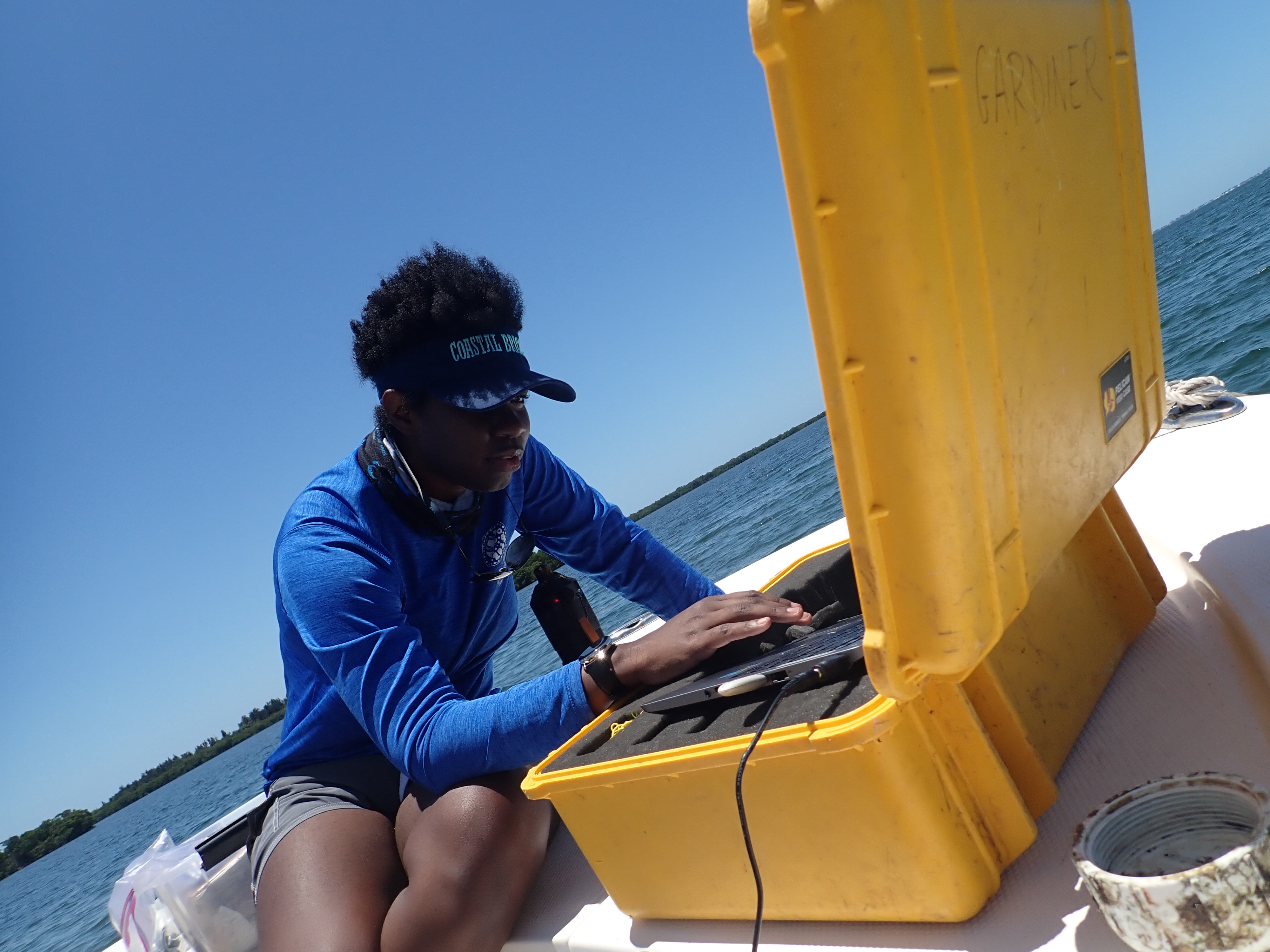 Jasmin working with scientific instruments on a boat