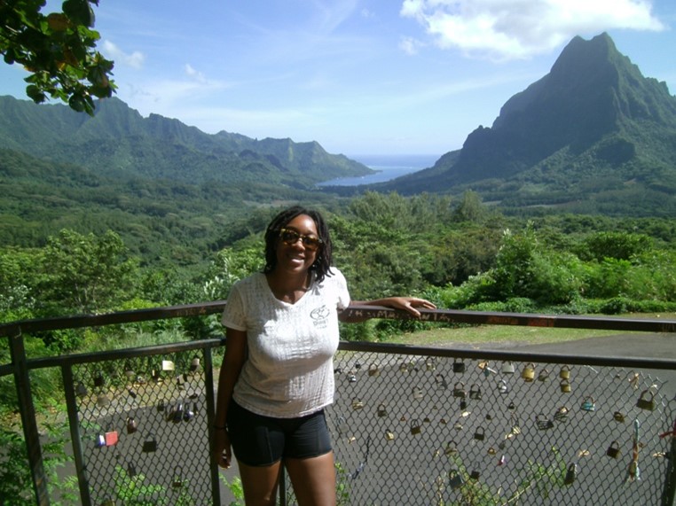 Camille outdoors in front of some lush greenery